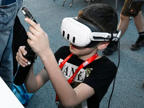 Young participant during virtual welding training with a VR headset and virtual welding torch