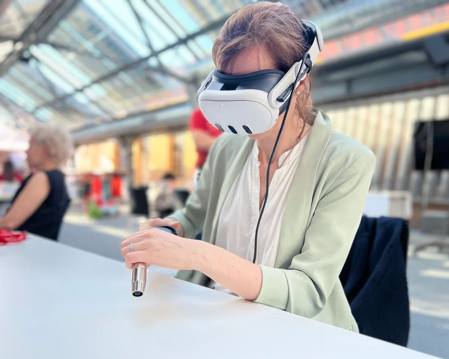 Participant practising virtual welding with a VR headset and virtual welding torch